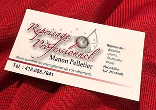 Professional mending business card on red knit fabric, textile repair service contact details