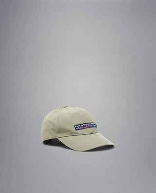Beige nylon baseball cap with embroidered nautical patch on front, isolated on gray background