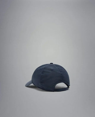 Rear view of a navy blue nylon baseball cap with adjustable strap on a neutral background