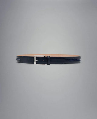 Navy blue leather belt with silver buckle and nautical flag accents on a grey background