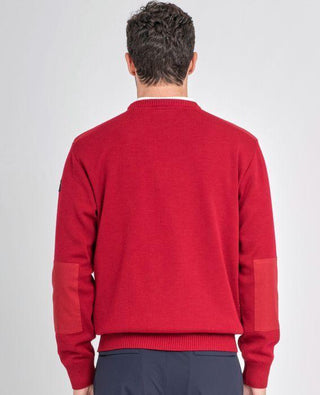 Man wearing red crew neck sweater with shoulder and elbow patches, back view