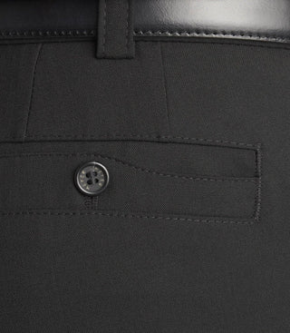Close-up of black dress pants pocket with button and belt loop detail